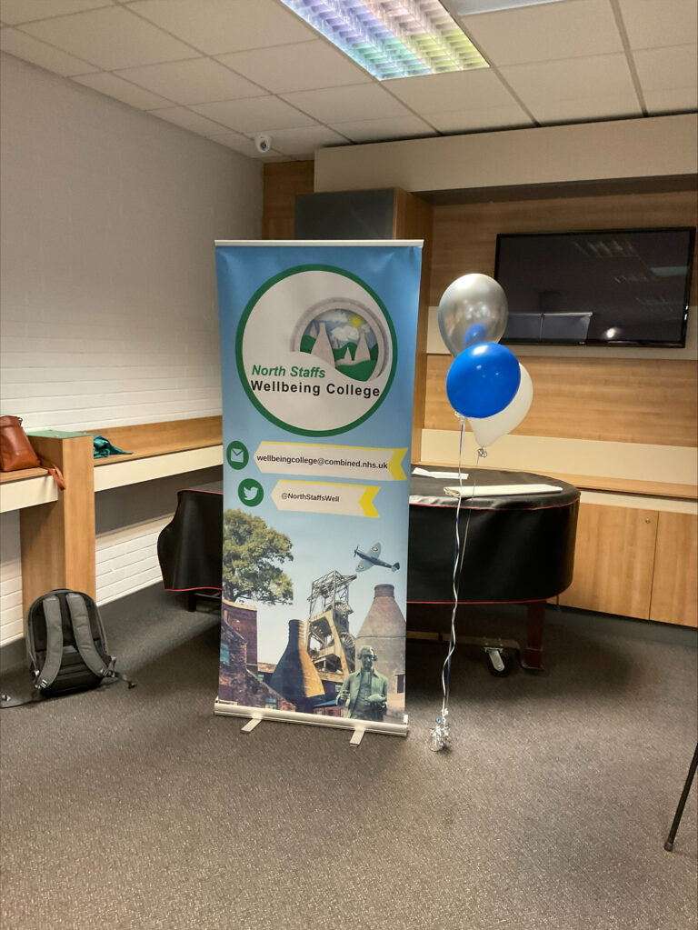 Wellbeing College banner with balloons at Peer support workers open day, the Bridge Centre